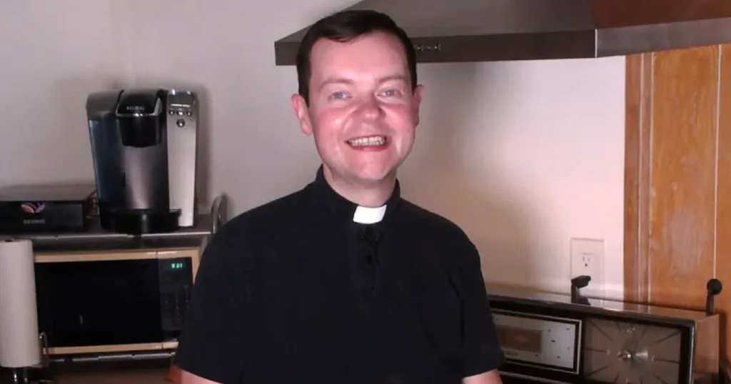 Portrait of Adam Kotas smiling at a public event