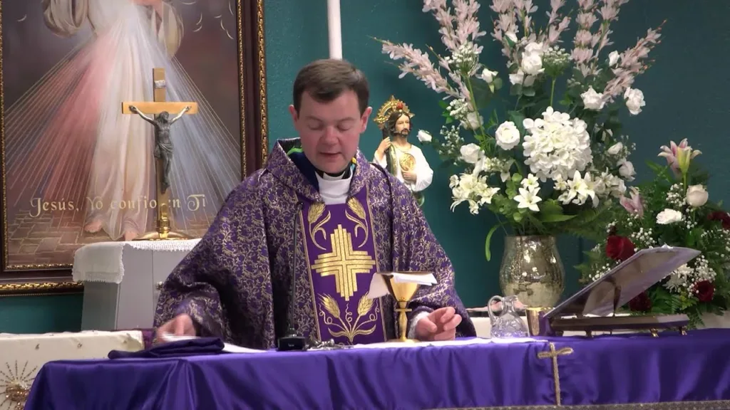 Adam Kotas speaking at a conference in 2025